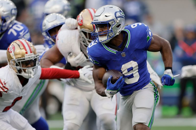 Seattle Seahawks running back Kenneth Walker III (9) runs during the first half of an NFL football game against the San Francisco 49ers, Thursday, Oct. 10, 2024, in Seattle. (AP Photo/John Froschauer)