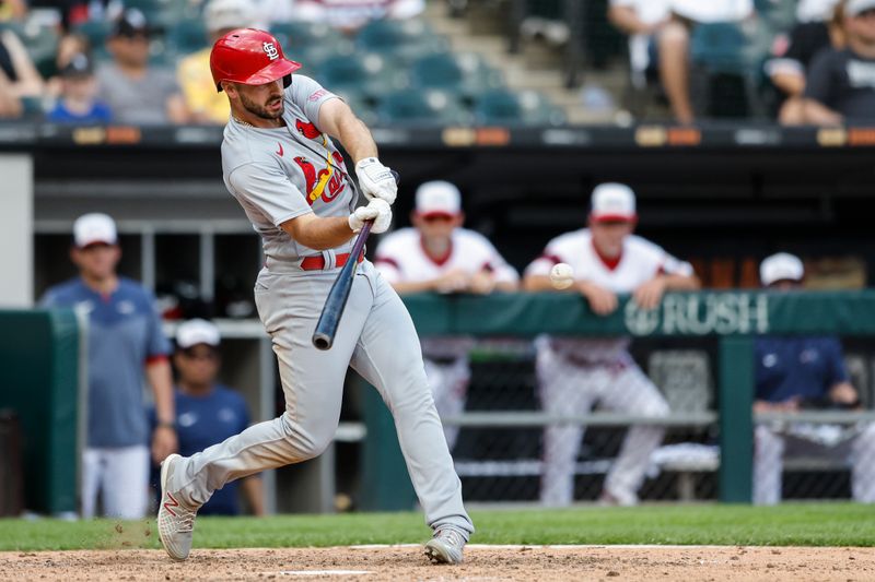 Jul 9, 2023; Chicago, Illinois, USA; St. Louis Cardinals shortstop Paul DeJong (11) hits a RBI-double against the Chicago White Sox during the tenth inning at Guaranteed Rate Field. Mandatory Credit: Kamil Krzaczynski-USA TODAY Sports