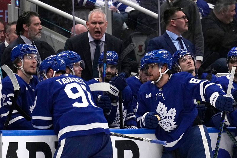 May 5, 2025; Toronto, Ontario, CAN; Toronto Maple Leafs head coach Craig Berube (center) talks to his players after a Florida Panthers goal during the third period of game one of the second round of the 2025 Stanley Cup Playoffs at Scotiabank Arena. Mandatory Credit: John E. Sokolowski-Imagn Images