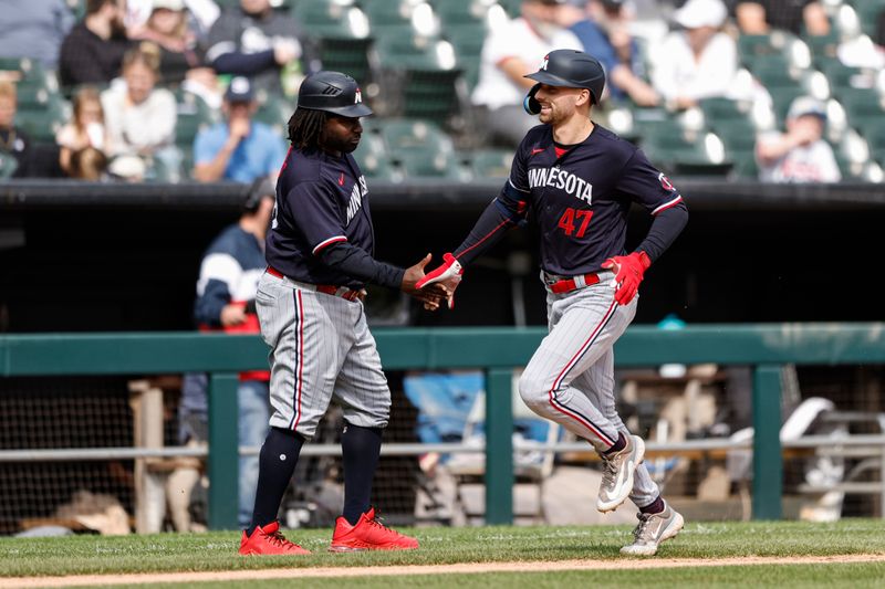 Sep 17, 2023; Chicago, Illinois, USA; Minnesota Twins second baseman Edouard Julien (47) celebrates with third base coach coach Tommy Watkins (40) as he rounds the bases after hitting a three-run home run against the Chicago White Sox during the fifth inning at Guaranteed Rate Field. Mandatory Credit: Kamil Krzaczynski-USA TODAY Sports