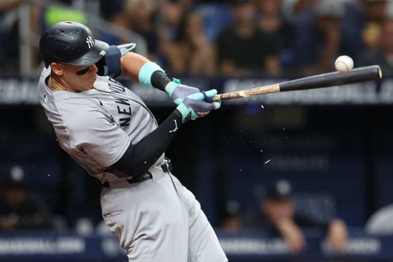 Jul 10, 2024; St. Petersburg, Florida, USA; New York Yankees designated hitter Aaron Judge (99) breaks his bat on a ground ball against the Tampa Bay Rays in the third inning at Tropicana Field. Mandatory Credit: Nathan Ray Seebeck-USA TODAY Sports