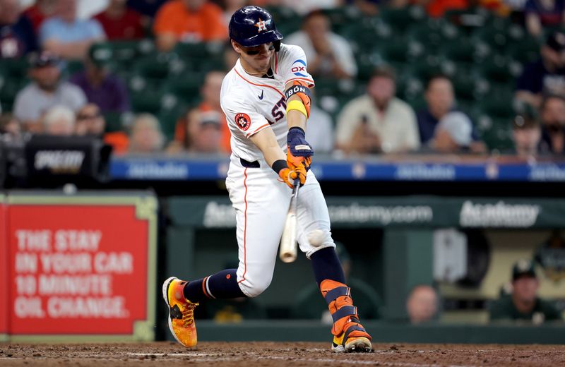 Sep 12, 2024; Houston, Texas, USA; Houston Astros second baseman Mauricio Dubon (14) hits an RBI single against the Oakland Athletics during the eighth inning at Minute Maid Park. Mandatory Credit: Erik Williams-Imagn Images