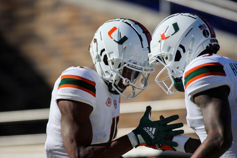 Nov 27, 2021; Durham, North Carolina, USA;  Miami Hurricanes wide receiver Charleston Rambo (11) and Miami Hurricanes wide receiver Mike Harley (3) celebrate a touchdown during the first half of the game against the Miami Hurricanes at Wallace Wade Stadium. at Wallace Wade Stadium. Mandatory Credit: Jaylynn Nash-USA TODAY Sports