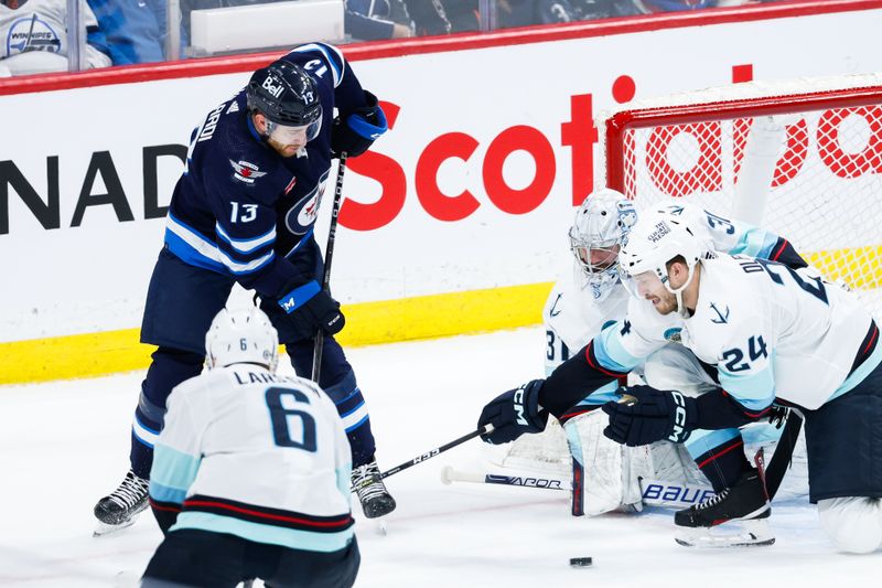 Apr 16, 2024; Winnipeg, Manitoba, CAN;  Seattle Kraken defenseman Jamie Oleksiak (24), Seattle Kraken goalie Philipp Grubauer (31) and Winnipeg Jets forward Gabriel Vilardi (13) look for the puck during the third period at Canada Life Centre. Mandatory Credit: Terrence Lee-USA TODAY Sports