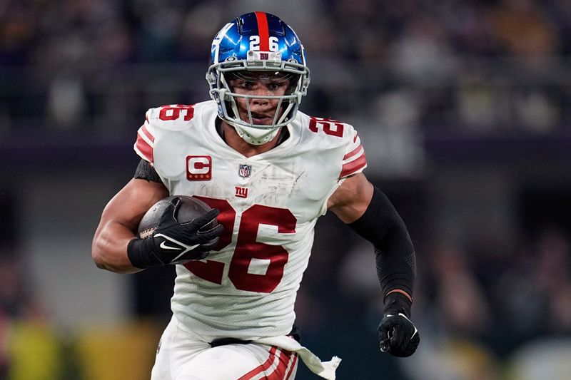 FILE - New York Giants' Saquon Barkley plays during the second half of an NFL wild-card football game against the Minnesota Vikings, Jan. 15, 2023, in Minneapolis. Barkley and the Giants failed to reach an agreement on a long-term contract extension by the Monday, July 17, 2023, deadline for franchised players, leaving the star running back with the option of playing for the tag-mandated $10.1 million salary or maybe taking the season off. (AP Photo/Abbie Parr, File)