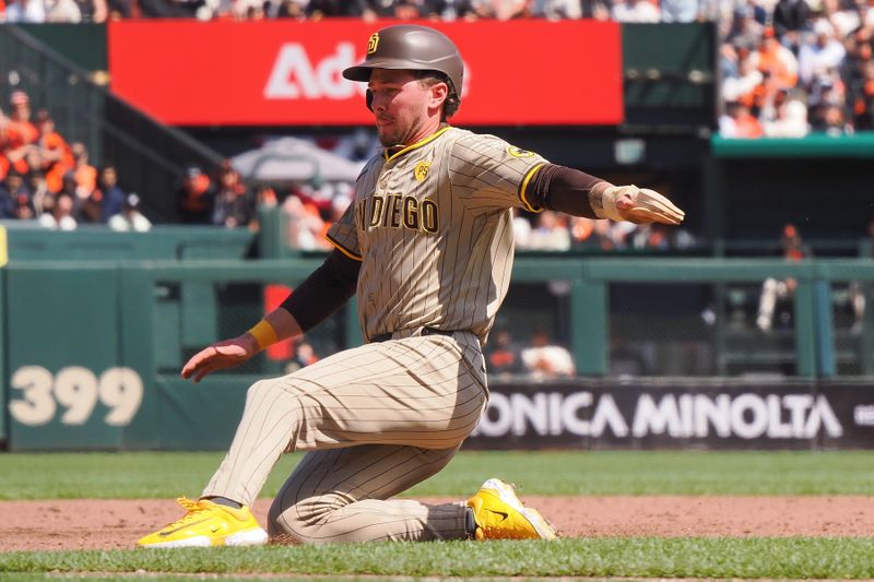 Apr 5, 2024; San Francisco, California, USA; San Diego Padres center fielder Jackson Merrill (3) slides safely to third base against the San Francisco Giants during the third inning at Oracle Park. Mandatory Credit: Kelley L Cox-USA TODAY Sports