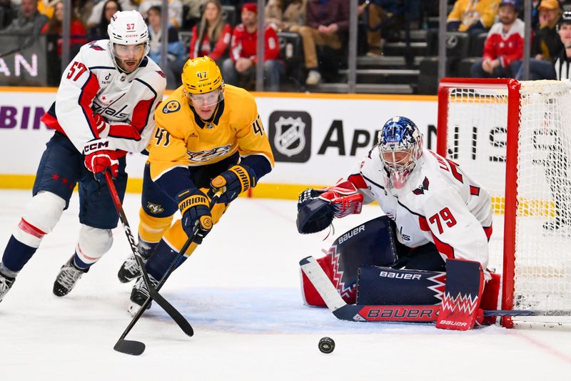 Jan 11, 2026; Nashville, Tennessee, USA;  Washington Capitals goaltender Charlie Lindgren (79) blocks the shot of Nashville Predators right wing Michael McCarron (47) during the third period at Bridgestone Arena. Mandatory Credit: Steve Roberts-Imagn Images