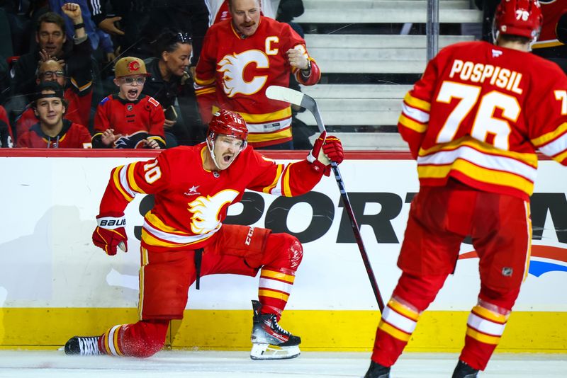 Nov 11, 2024; Calgary, Alberta, CAN; Calgary Flames center Jonathan Huberdeau (10) celebrates his goal with teammates against the Los Angeles Kings during the second period at Scotiabank Saddledome. Mandatory Credit: Sergei Belski-Imagn Images