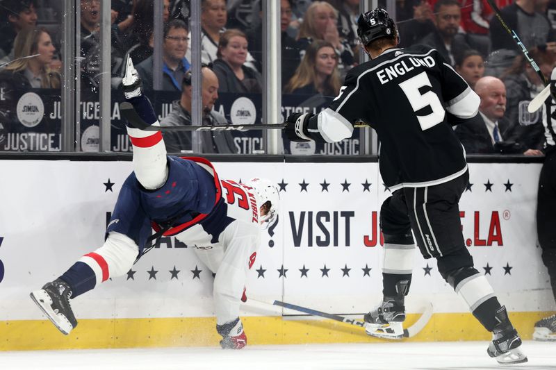 Nov 29, 2023; Los Angeles, California, USA; Los Angeles Kings defenseman Andreas Englund (5) escapes a check by Washington Capitals right wing Nicolas Aube-Kubel (96) during the first period at Crypto.com Arena. Mandatory Credit: Kiyoshi Mio-USA TODAY Sports