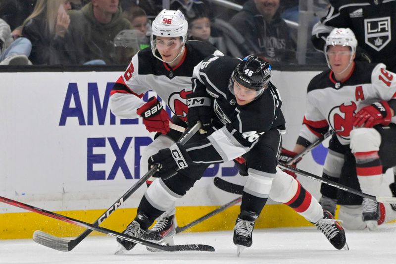 Mar 3, 2024; Los Angeles, California, USA;  Los Angeles Kings center Blake Lizotte (46) skates the puck away from New Jersey Devils center Jack Hughes (86) in the second period at Crypto.com Arena. Mandatory Credit: Jayne Kamin-Oncea-USA TODAY Sports