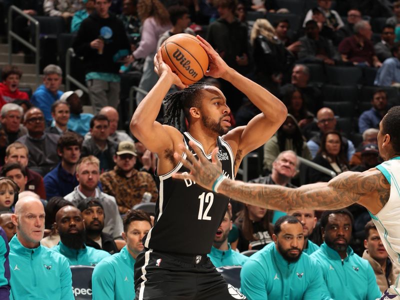 CHARLOTTE, NC - JANUARY 29: Tosan Evbuomwan #12 of the Brooklyn Nets handles the ball during the game against the Charlotte Hornets  on January 29, 2025 at Spectrum Center in Charlotte, North Carolina. NOTE TO USER: User expressly acknowledges and agrees that, by downloading and or using this photograph, User is consenting to the terms and conditions of the Getty Images License Agreement. Mandatory Copyright Notice: Copyright 2025 NBAE (Photo by Kent Smith/NBAE via Getty Images)