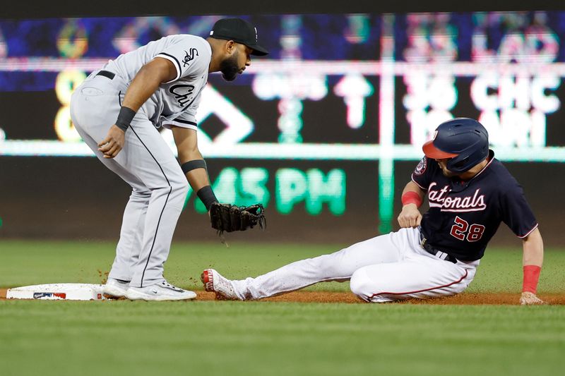 Sep 18, 2023; Washington, District of Columbia, USA; Washington Nationals right fielder Lane Thomas (28) steals second base ahead of an attempted tag by Chicago White Sox second baseman Elvis Andrus (1) at Nationals Park. Mandatory Credit: Geoff Burke-USA TODAY Sports