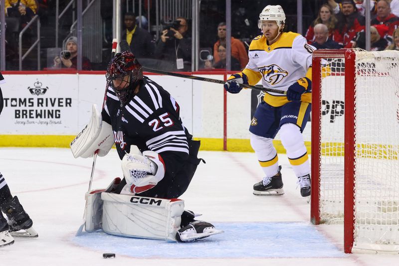 Nov 25, 2024; Newark, New Jersey, USA; New Jersey Devils goaltender Jacob Markstrom (25) makes a save against the Nashville Predators during the first period at Prudential Center. Mandatory Credit: Ed Mulholland-Imagn Images