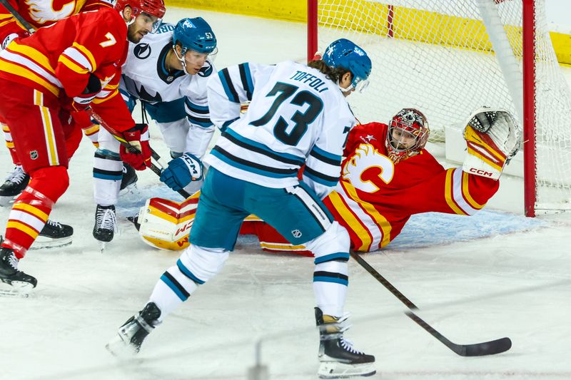 Apr 13, 2025; Calgary, Alberta, CAN; San Jose Sharks center Tyler Toffoli (73) scores a goal against Calgary Flames goaltender Dustin Wolf (32) during the first period at Scotiabank Saddledome. Mandatory Credit: Sergei Belski-Imagn Images