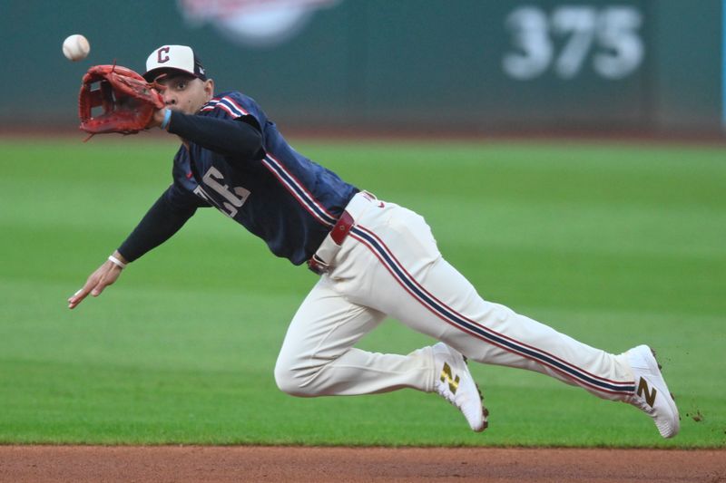 Sep 18, 2024; Cleveland, Ohio, USA; Cleveland Guardians second baseman Andres Gimenez (0) reaches for a ground ball in the first inning against the Minnesota Twins at Progressive Field. Mandatory Credit: David Richard-Imagn Images