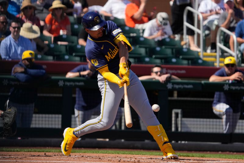 Mar 5, 2024; Scottsdale, Arizona, USA; Milwaukee Brewers shortstop Willy Adames (27) hits an RBI triple against the San Francisco Giants in the first inning at Scottsdale Stadium. Mandatory Credit: Rick Scuteri-USA TODAY Sports