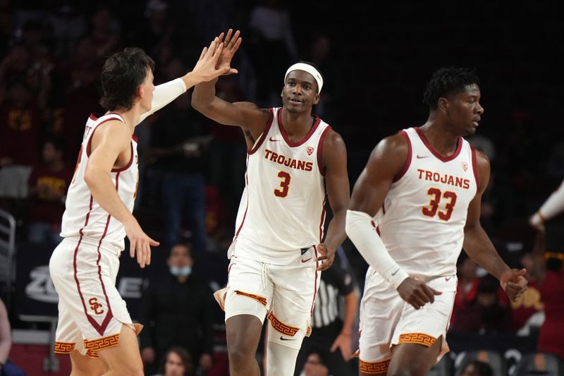 Nov 29, 2023; Los Angeles, California, USA Southern California Trojans forward Vincent Iwuchukwu (3) celebrates with forward Kijani Wright (33) and forward Harrison Hornery (30) in the first half against the Eastern Washington Eagles at Galen Center. Mandatory Credit: Kirby Lee-USA TODAY Sports