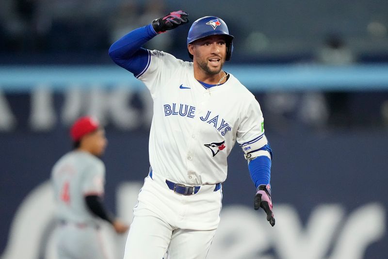 Aug 20, 2024; Toronto, Ontario, CAN; Toronto Blue Jays designated hitter George Springer (4) celebrates his two-run home run against the Cincinnati Reds as he rounds the bases during the second inning at Rogers Centre. Mandatory Credit: John E. Sokolowski-USA TODAY Sports