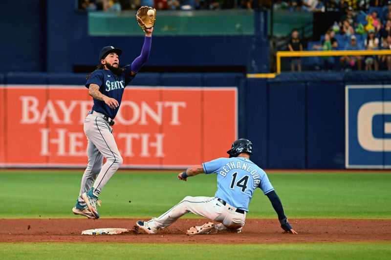 Sep 10, 2023; St. Petersburg, Florida, USA;  Seattle Mariners shortstop J.P. Crawford (3) jumps to catch the ball as Tampa Bay Rays catcher Christian Bethancourt (14) slides into second base  in the sixth inning  at Tropicana Field. Mandatory Credit: Jonathan Dyer-USA TODAY Sports