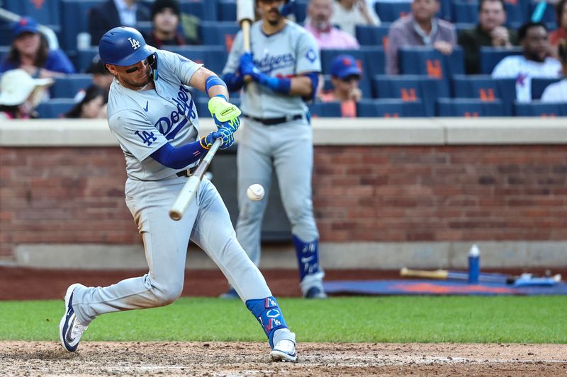 May 29, 2024; New York City, New York, USA;  Los Angeles Dodgers second baseman Miguel Rojas (11) hits an RBI single in the eighth inning against the New York Mets at Citi Field. Mandatory Credit: Wendell Cruz-USA TODAY Sports