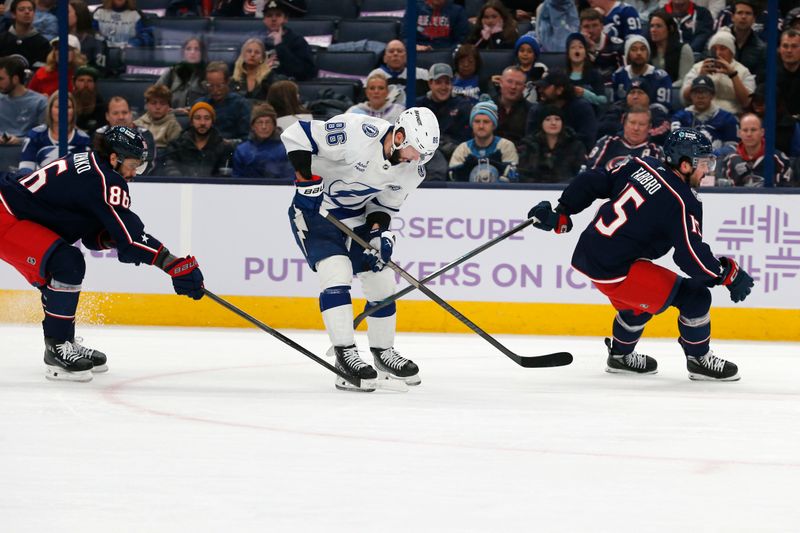 Nov 21, 2024; Columbus, Ohio, USA; Tampa Bay Lightning right wing Nikita Kucherov carries the puck past Columbus Blue Jackets right wing Kirill Marchenko (86) during the first period at Nationwide Arena. Mandatory Credit: Russell LaBounty-Imagn Images