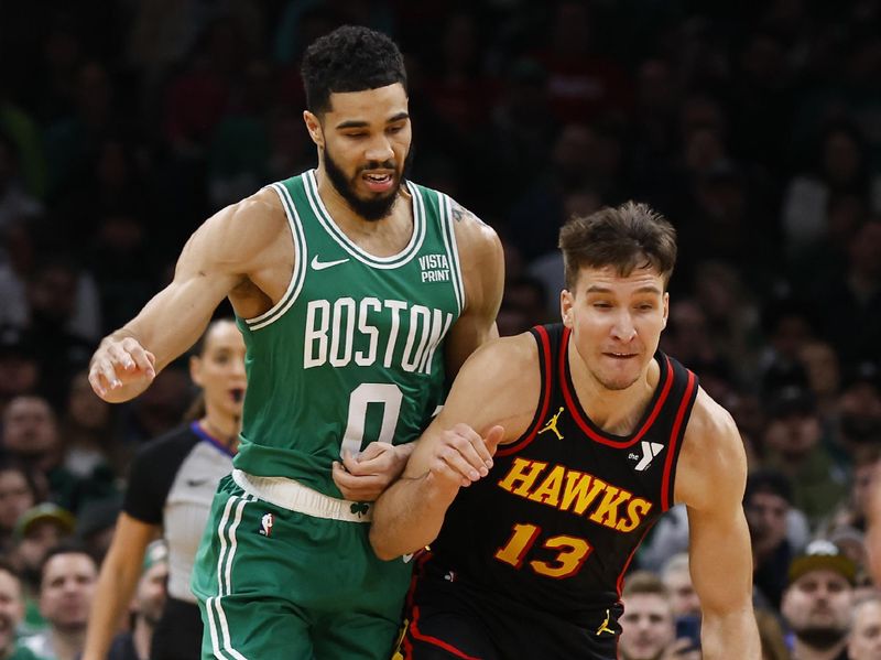 BOSTON, MA - FEBRUARY 7: Bogdan Bogdanovic #13 of the Atlanta Hawks and Jayson Tatum #0 of the Boston Celtics collide during the first quarter at TD Garden on February 7, 2024 in Boston, Massachusetts. NOTE TO USER: User expressly acknowledges and agrees that, by downloading and/or using this Photograph, user is consenting to the terms and conditions of the Getty Images License Agreement. (Photo By Winslow Townson/Getty Images)