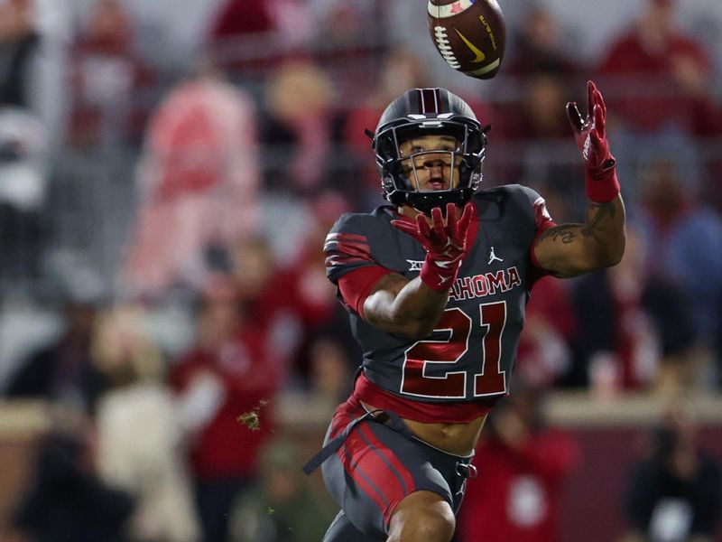 Nov 11, 2023; Norman, Oklahoma, USA;  Oklahoma Sooners defensive back Reggie Pearson (21) makes an interception during the second half against the West Virginia Mountaineers at Gaylord Family-Oklahoma Memorial Stadium. Mandatory Credit: Kevin Jairaj-USA TODAY Sports