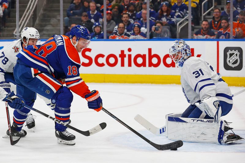 Jan 16, 2024; Edmonton, Alberta, CAN; Edmonton Oilers forward Zach Hyman (18) takes a shot on Toronto Maple Leafs goaltender Martin Jones (31) during the first period at Rogers Place. Mandatory Credit: Perry Nelson-USA TODAY Sports