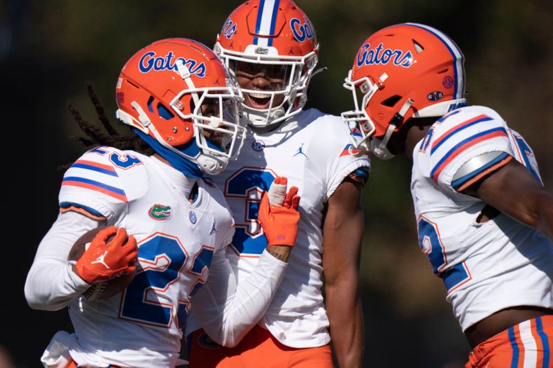 Nov 19, 2022; Nashville, Tennessee, USA;  Florida cornerback Jaydon Hill (23) celebrates after recovering a Vanderbilt fumble with teammates cornerback Jason Marshall Jr. (3) and linebacker Antwaun Powell-Ryland Jr. (52) during the first quarter at FirstBank Stadium. Mandatory Credit: George Walker IV - USA TODAY Sports