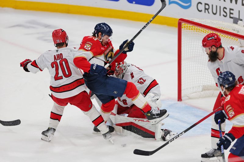 May 24, 2025; Sunrise, Florida, USA; Florida Panthers left wing Matthew Tkachuk (19) moves the puck as Carolina Hurricanes goaltender Pyotr Kochetkov (52) defends during the second period in game three of the Eastern Conference Final of the 2025 Stanley Cup Playoffs at Amerant Bank Arena. Mandatory Credit: Sam Navarro-Imagn Images