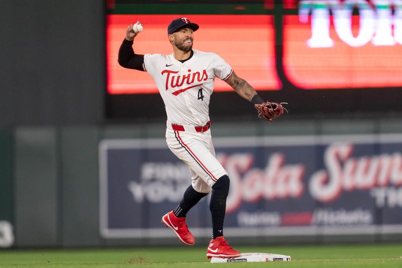 May 15, 2024; Minneapolis, Minnesota, USA; Minnesota Twins shortstop Carlos Correa (4) steps on second base retiring New York Yankees shortstop Anthony Volpe (11) and throws to first to retire New York Yankees right fielder Juan Soto (22) for the double play at Target Field. Mandatory Credit: Matt Blewett-USA TODAY Sports