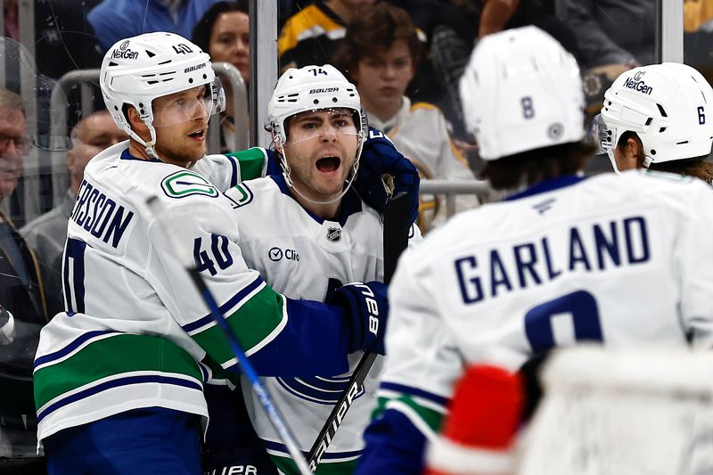 Nov 26, 2024; Boston, Massachusetts, USA; Vancouver Canucks left wing Jake DeBrusk (74) is congratulated by center Elias Pettersson (40) after scoring against the Boston Bruins during the second period at TD Garden. Mandatory Credit: Winslow Townson-Imagn Images