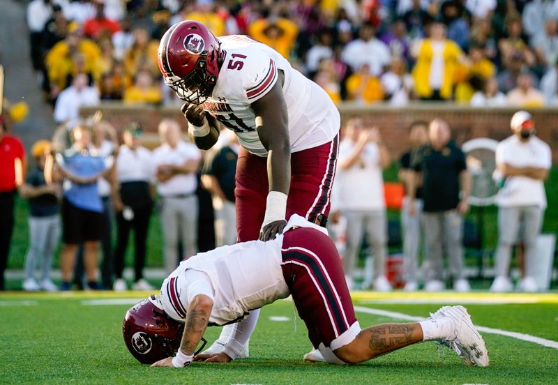 Oct 21, 2023; Columbia, Missouri, USA; South Carolina Gamecocks offensive lineman Tree Babalade (51) checks on quarterback Spencer Rattler (7) after a play during the second half against the Missouri Tigers at Faurot Field at Memorial Stadium. Mandatory Credit: Jay Biggerstaff-USA TODAY Sports