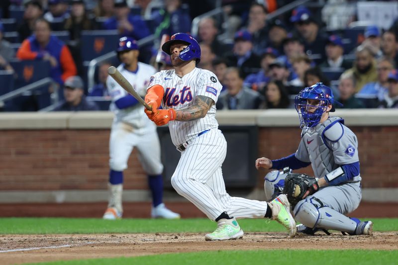 Oct 18, 2024; New York City, New York, USA; New York Mets catcher Francisco Alvarez (4) hits a single in the third inning against the Los Angeles Dodgers during game five of the NLCS for the 2024 MLB playoffs at Citi Field. Mandatory Credit: Brad Penner-Imagn Images