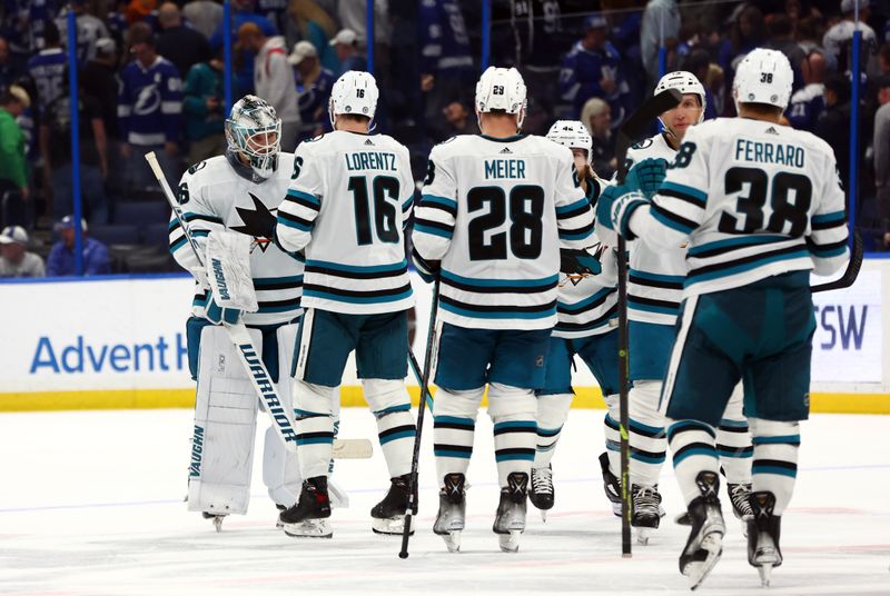 Feb 7, 2023; Tampa, Florida, USA; San Jose Sharks goaltender Kaapo Kahkonen (36) is congratulated by teammates after they beat the Tampa Bay Lightning in overtime at Amalie Arena. Mandatory Credit: Kim Klement-USA TODAY Sports