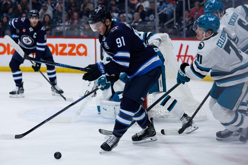 Apr 16, 2026; Winnipeg, Manitoba, CAN; Winnipeg Jets forward Cole Perfetti (91) shields the puck from San Jose Sharks forward Macklin Celebrini (71) during the second period at Canada Life Centre. Mandatory Credit: Terrence Lee-Imagn Images Apr 16, 2026; Winnipeg, Manitoba, CAN; Winnipeg Jets forward Cole Perfetti (91) shields the puck from San Jose Sharks forward Macklin Celebrini (71) during the second period at Canada Life Centre. Mandatory Credit: Terrence Lee-Imagn Images