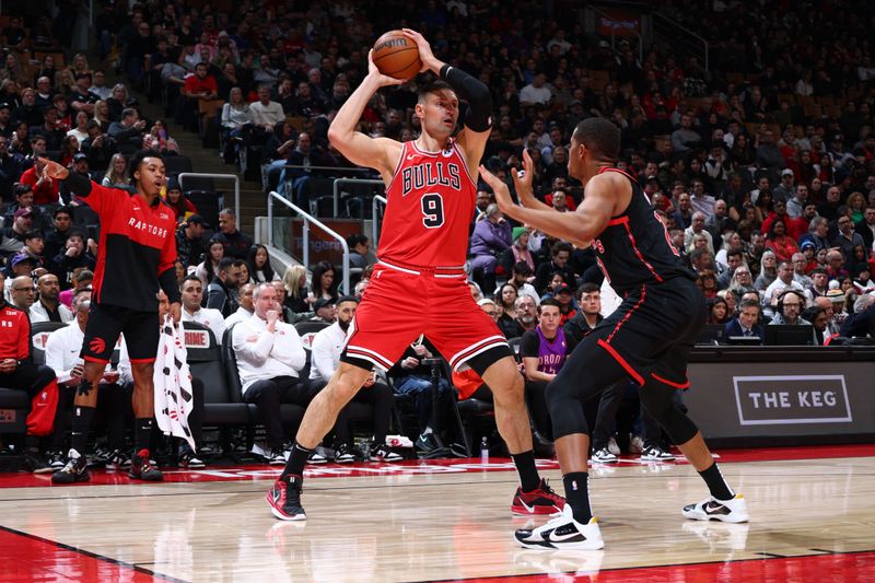 TORONTO, CANADA - JANUARY 31: Nikola Vucevic #9 of the Chicago Bulls looks to pass the ball during the game against the Toronto Raptors  on January 31, 2025 at the Scotiabank Arena in Toronto, Ontario, Canada.  NOTE TO USER: User expressly acknowledges and agrees that, by downloading and or using this Photograph, user is consenting to the terms and conditions of the Getty Images License Agreement.  Mandatory Copyright Notice: Copyright 2025 NBAE (Photo by Vaughn Ridley/NBAE via Getty Images)