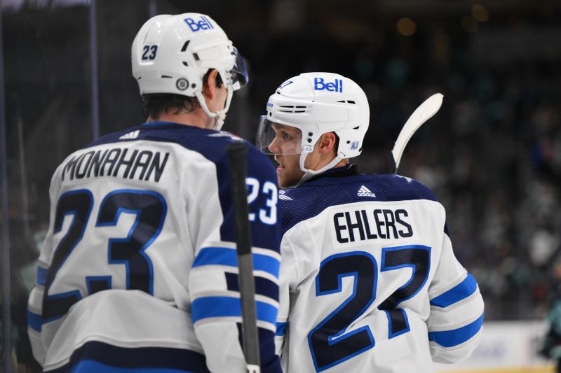 Mar 8, 2024; Seattle, Washington, USA; Winnipeg Jets center Sean Monahan (23) and left wing Nikolaj Ehlers (27) celebrate after Ehlers scored an empty net goal against the Seattle Kraken during the third period at Climate Pledge Arena. Mandatory Credit: Steven Bisig-USA TODAY Sports