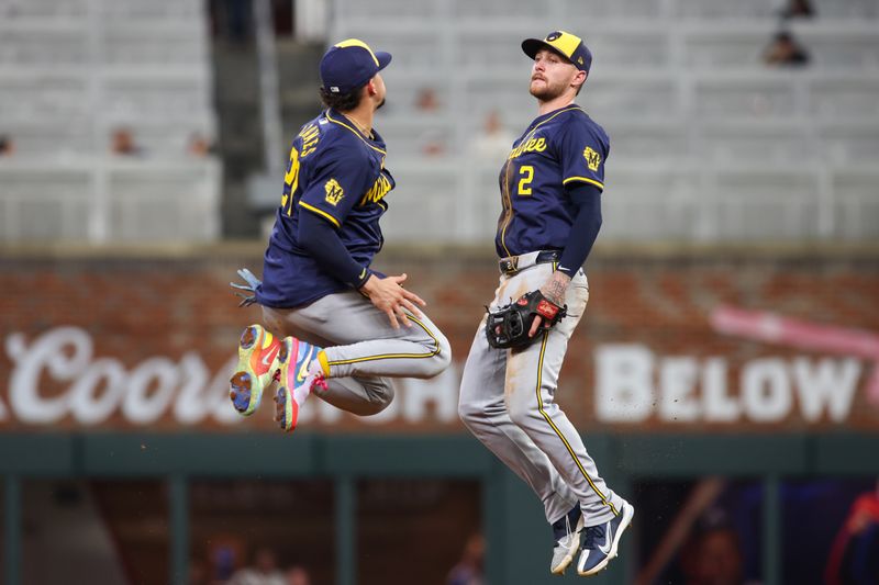 Aug 6, 2024; Atlanta, Georgia, USA; Milwaukee Brewers shortstop Willy Adames (27) and second baseman Brice Turang (2) celebrate after a victory against the Atlanta Braves at Truist Park. Mandatory Credit: Brett Davis-USA TODAY Sports