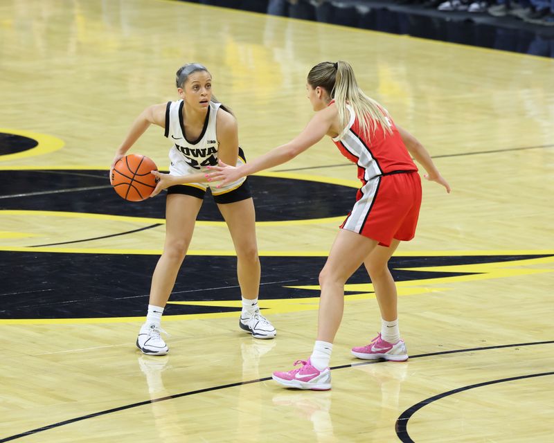 Mar 3, 2024; Iowa City, Iowa, USA; Ohio State Buckeyes guard Jacy Sheldon (4) defends Iowa Hawkeyes guard Gabbie Marshall (24) during the first half at Carver-Hawkeye Arena. Mandatory Credit: Reese Strickland-USA TODAY Sports