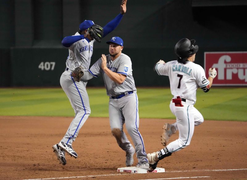 Apr 25, 2023; Phoenix, Arizona, USA; Arizona Diamondbacks left fielder Corbin Carroll (7) reaches first base safely as Kansas City Royals first baseman Vinnie Pasquantino (9) and Kansas City Royals relief pitcher Aroldis Chapman (54) collide at first base during the eighth inning at Chase Field. Mandatory Credit: Joe Camporeale-USA TODAY Sports