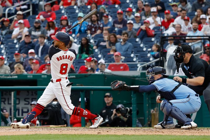 May 5, 2024; Washington, District of Columbia, USA; Washington Nationals outfielder Eddie Rosario (8) hits a go ahead two run home run against the Toronto Blue Jays during the seventh inning at Nationals Park. Mandatory Credit: Geoff Burke-USA TODAY Sports
