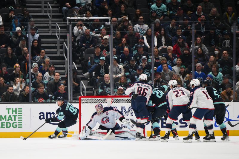 Nov 12, 2024; Seattle, Washington, USA; Seattle Kraken left wing Andre Burakovsky (95) skates around the goal during the second period against the Columbus Blue Jackets at Climate Pledge Arena. Mandatory Credit: Steven Bisig-Imagn Images