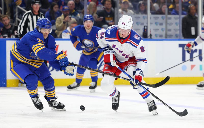 Oct 9, 2025; Buffalo, New York, USA;  New York Rangers center Adam Edstrom (84) looks to control the puck as Buffalo Sabres defenseman Ryan Johnson (33) defends during the second period at KeyBank Center. Mandatory Credit: Timothy T. Ludwig-Imagn Images