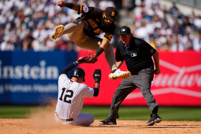 May 28, 2023; Bronx, New York, USA; New York Yankees left fielder Isiah Kiner-Falefa (12) steals second base ahead of San Diego Padres second baseman Rougned Odor (24) leaping tag during the eighth inning at Yankee Stadium. Mandatory Credit: Gregory Fisher-USA TODAY Sports