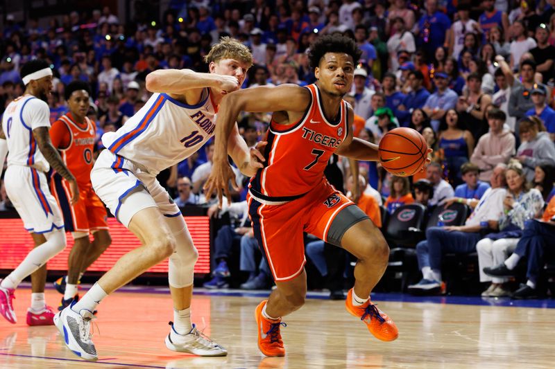Jan 24, 2026; Gainesville, Florida, USA; Auburn Tigers guard Keyshawn Hall (7) drives to the basket past Florida Gators forward Thomas Haugh (10) during the first half at Exactech Arena at the Stephen C. O'Connell Center. Mandatory Credit: Matt Pendleton-Imagn Images