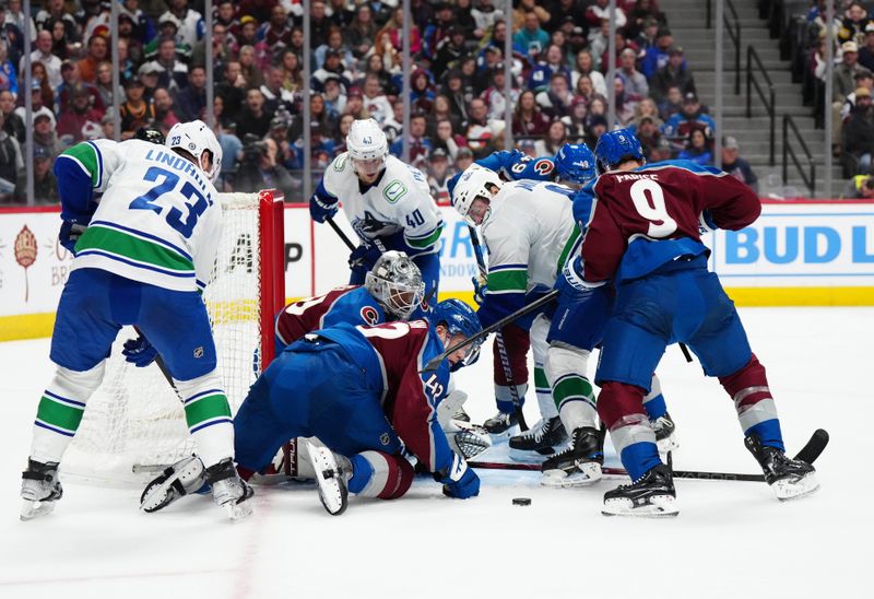 Feb 20, 2024; Denver, Colorado, USA; Colorado Avalanche goaltender Alexandar Georgiev (40) and defenseman Josh Manson (42) and left wing Zach Parise (9) Vancouver Canucks center Elias Lindholm (23) and center Elias Pettersson (40) center J.T. Miller (9) during the third period at Ball Arena. Mandatory Credit: Ron Chenoy-USA TODAY Sports