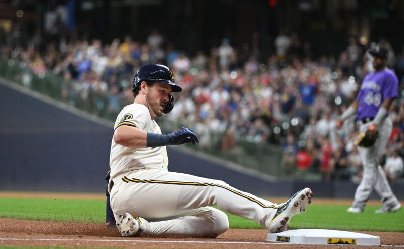 Aug 7, 2023; Milwaukee, Wisconsin, USA; Milwaukee Brewers third baseman Brian Anderson (9) slides safely into third base for a triple against the Colorado Rockies in the fourth inning at American Family Field. Mandatory Credit: Michael McLoone-USA TODAY Sports