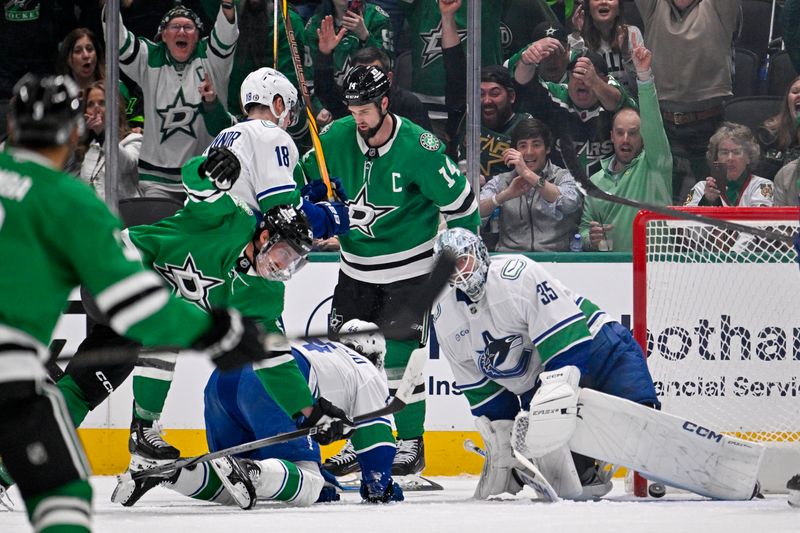Apr 8, 2025; Dallas, Texas, USA; Dallas Stars left wing Jamie Benn (14) celebrates a goal scored by left wing Mason Marchment (27) against Vancouver Canucks goaltender Thatcher Demko (35) during the first period at the American Airlines Center. Mandatory Credit: Jerome Miron-Imagn Images