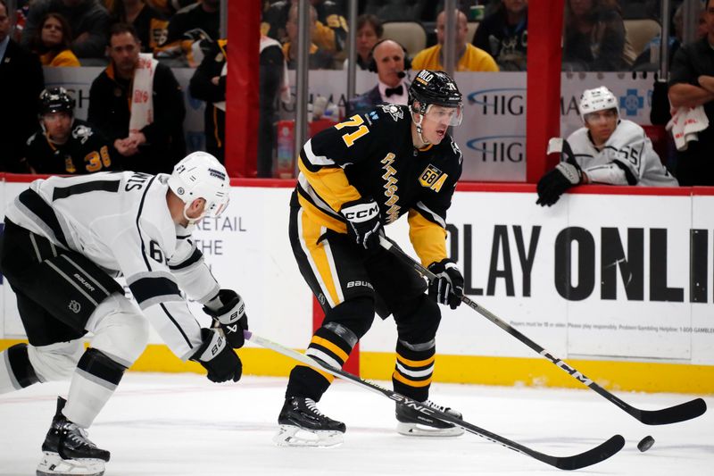 Feb 18, 2024; Pittsburgh, Pennsylvania, USA;  Pittsburgh Penguins center Evgeni Malkin (71) moves the puck ahead of Los Angeles Kings center Trevor Lewis (61) during the third period at PPG Paints Arena. Los Angeles won 2-1. Mandatory Credit: Charles LeClaire-USA TODAY Sports